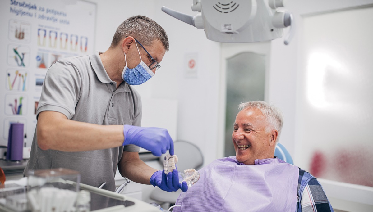 dentist-explaning-denture-work-to-happy-senior-patient-picture-id1200x683.jpg