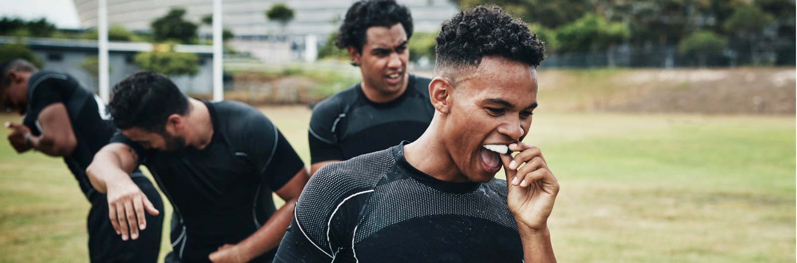 An athlete putting in a mouth guard