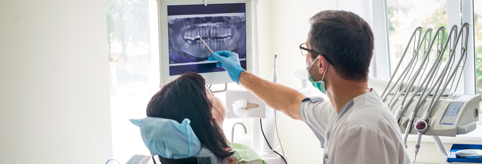 Dentist showing a tooth x-ray to a patient