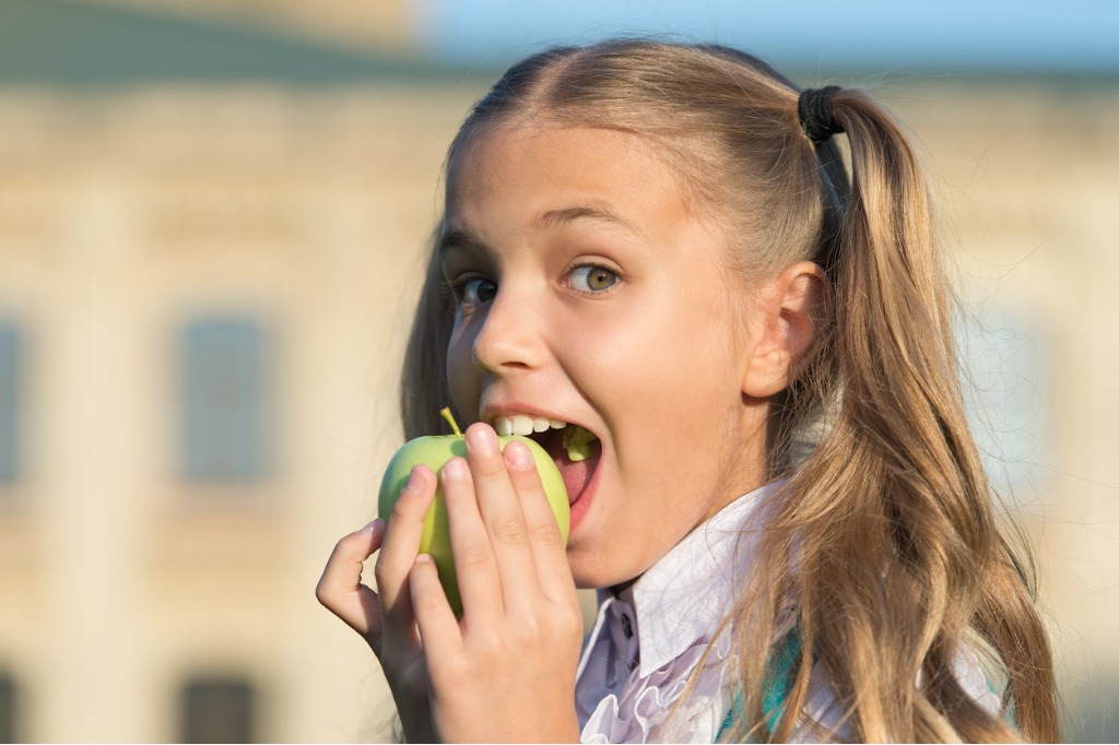 A young child eating an apple
