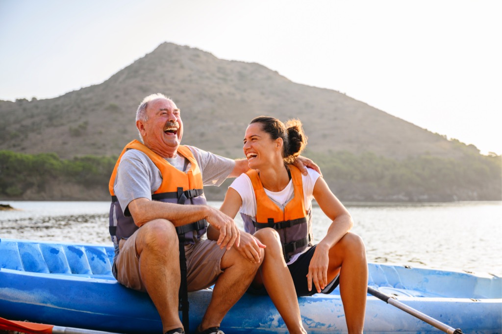 Two family members laughing while sitting on a kayak