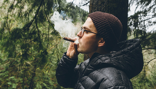 A man smoking a cigar outside