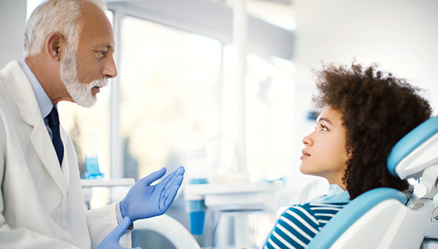 A dentist talking with a patient