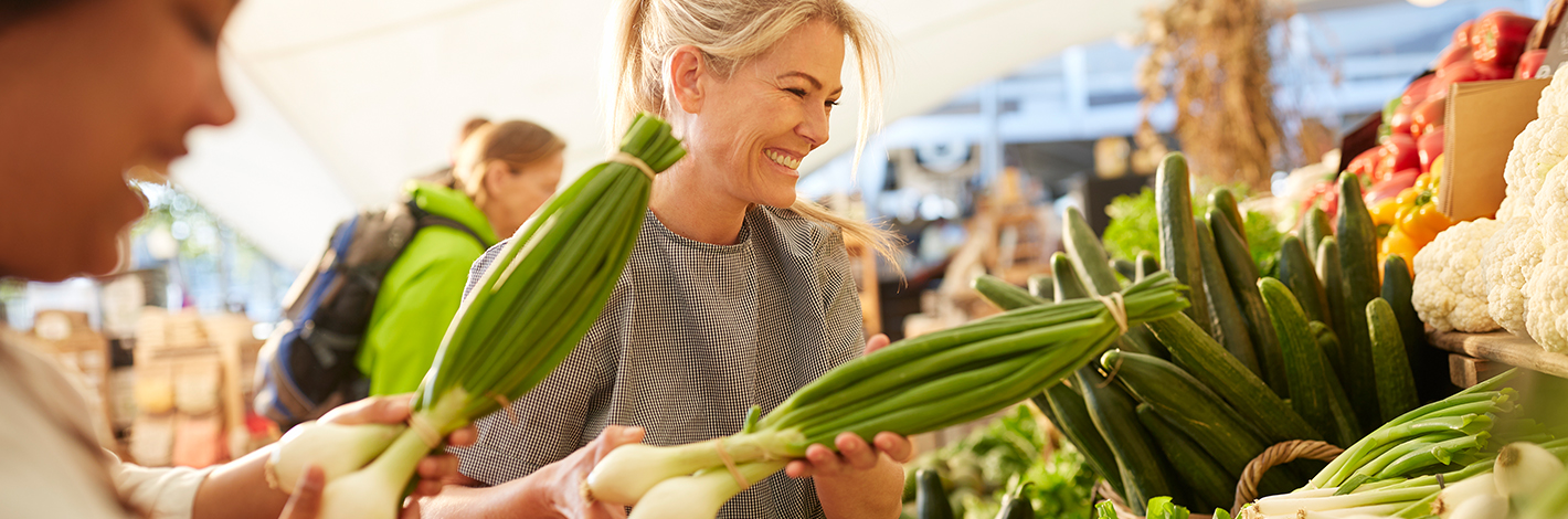A woman buying vegetables at a market