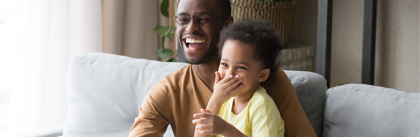 A father and son watching tv and laughing