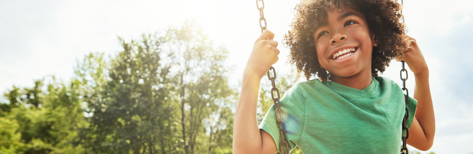 A child swinging and smiling