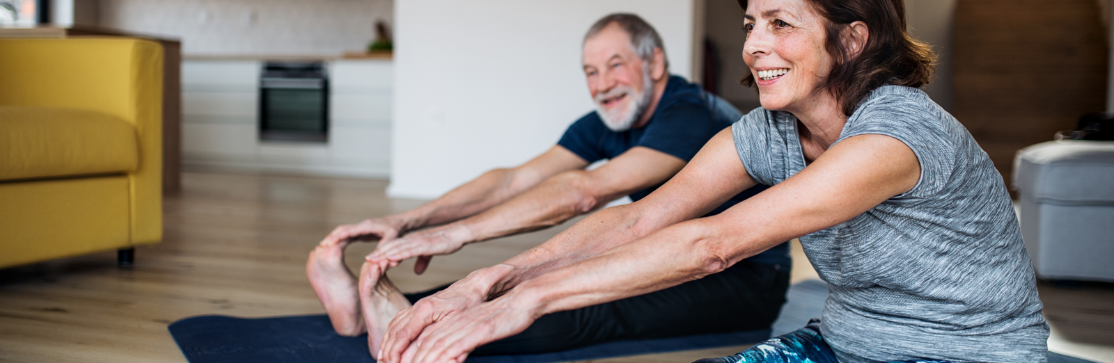 A couple stretching in their living room