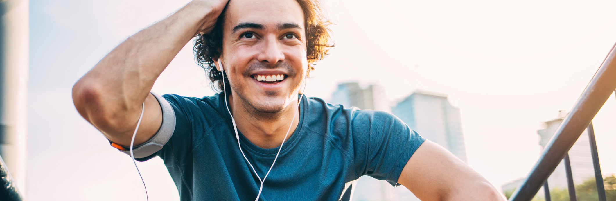 A man smiling while exercising outside