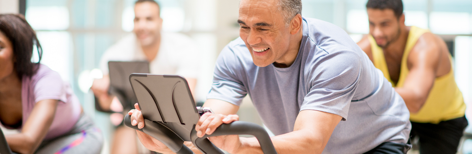 A man exercising in a spinning class