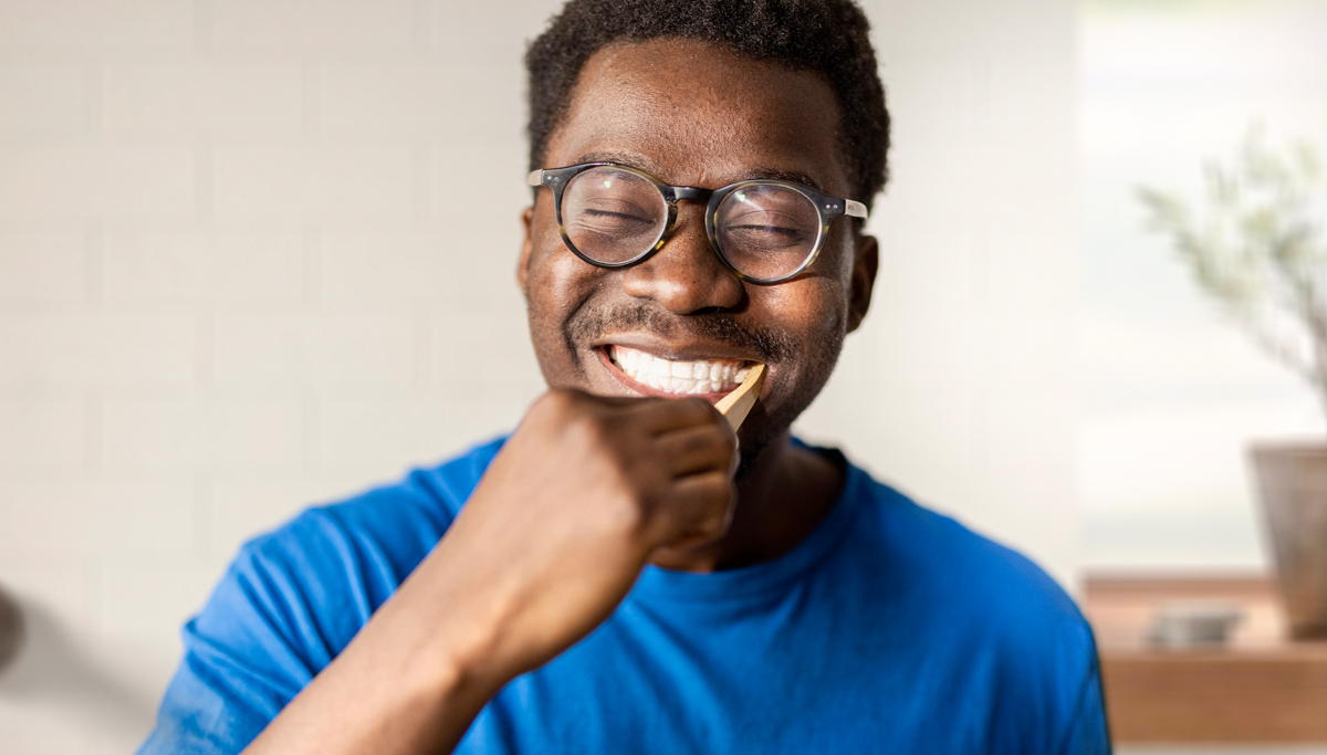 Man-smiling-and-brushing-teeth-1200x683.jpg