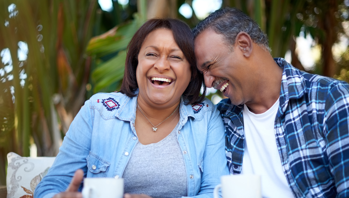 A couple sitting outside and laughing
