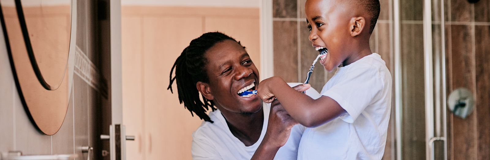 A father and son brushing their teeth