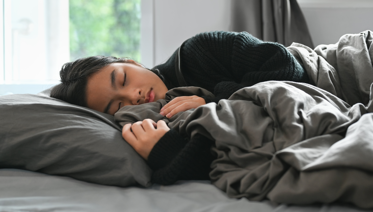 A woman laying in a bed sleeping
