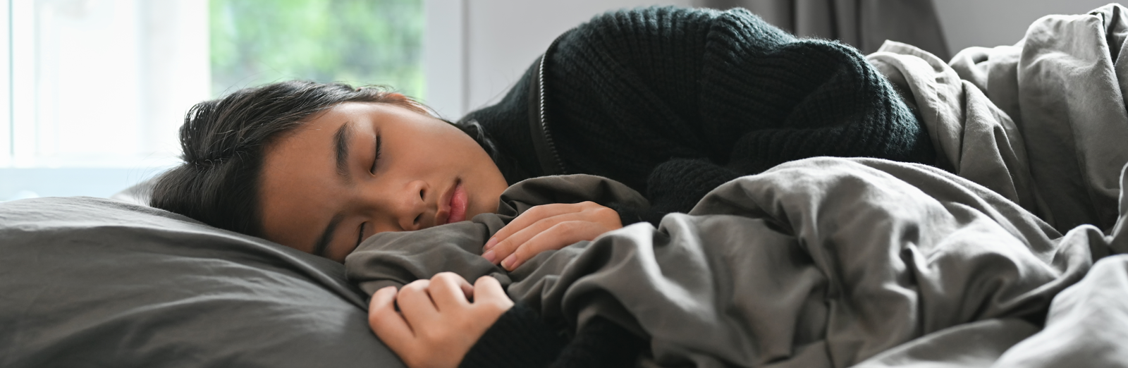 A woman laying in a bed sleeping