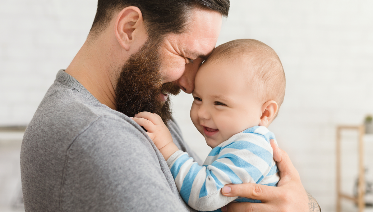 A father holding a baby