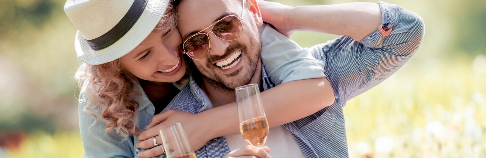 A couple drinking wine together in a field