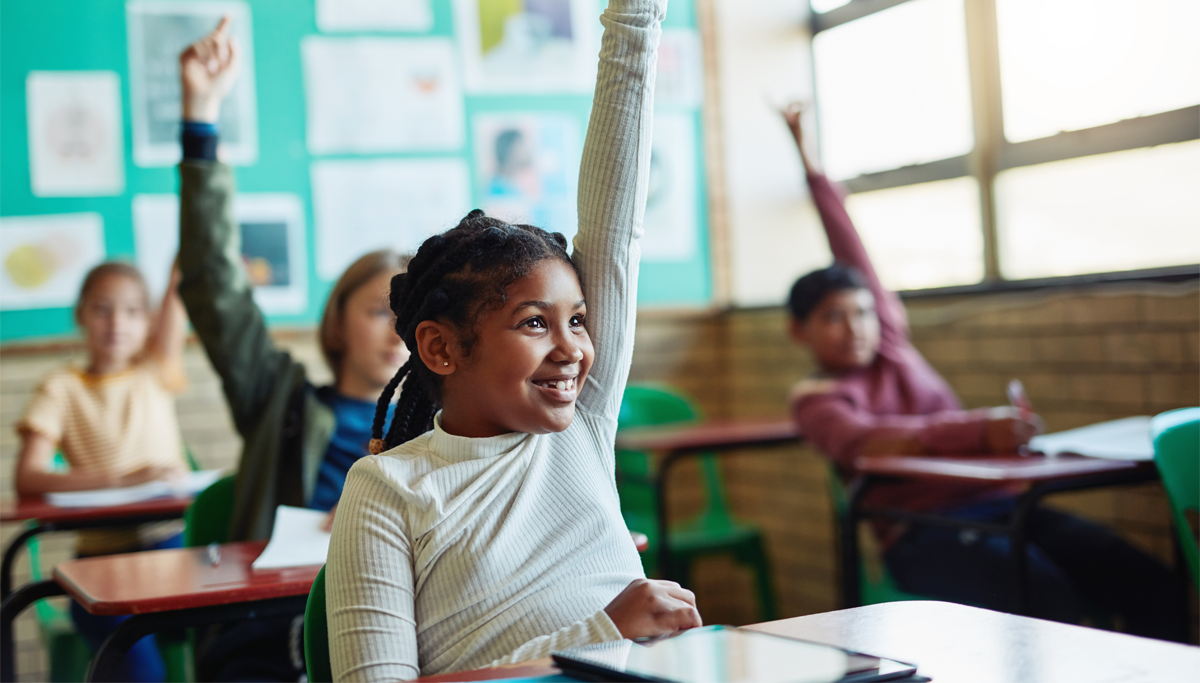 Students smiling and raising their hands