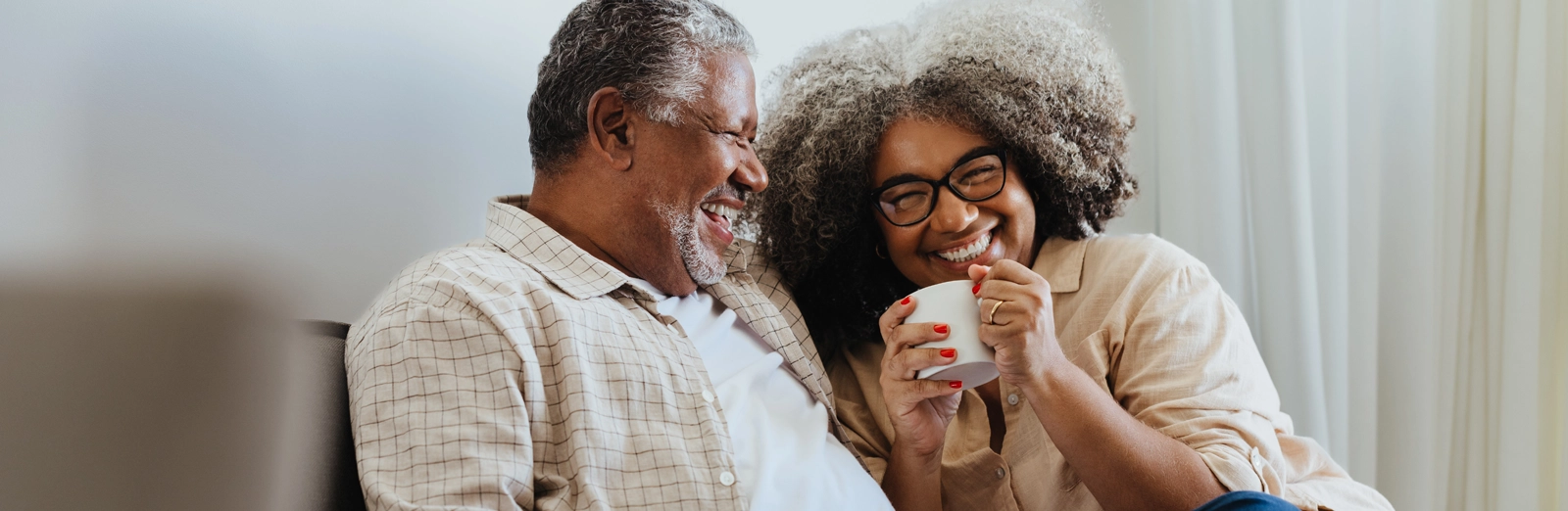 older-couple-laughing-together-1600x522.webp