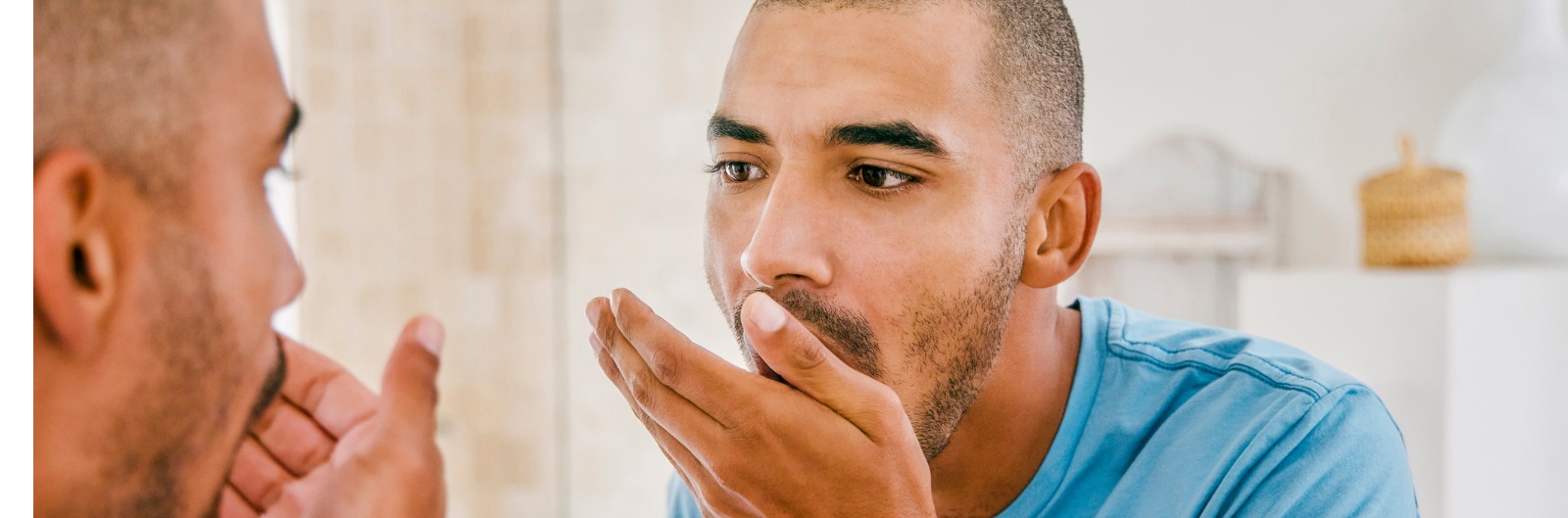 shot-of-a-young-man-smelling-his-breath-during-his-morning-grooming-picture-id1355106336.jpg