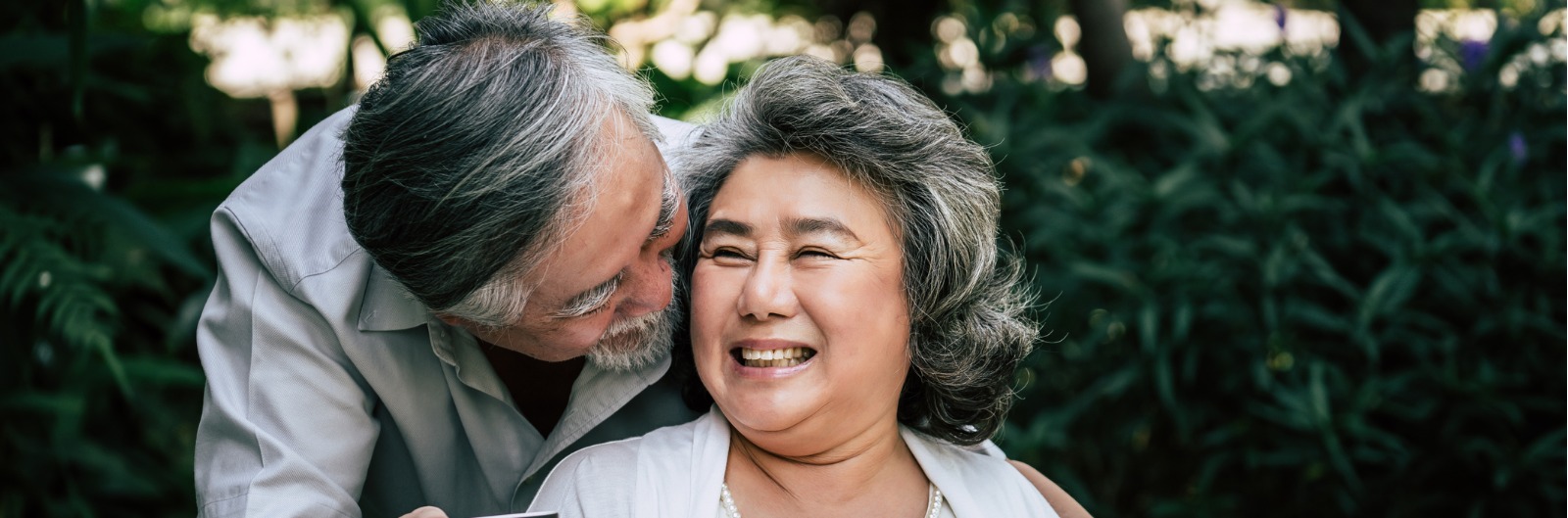 A couple sitting in a park drinking coffee