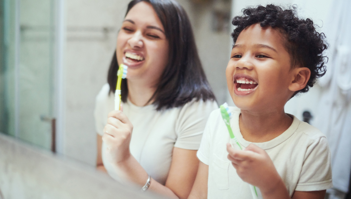 A mother and son brushing their teeth