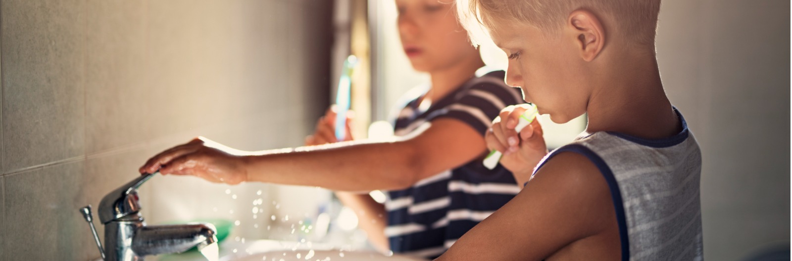 Two children brushing their teeth