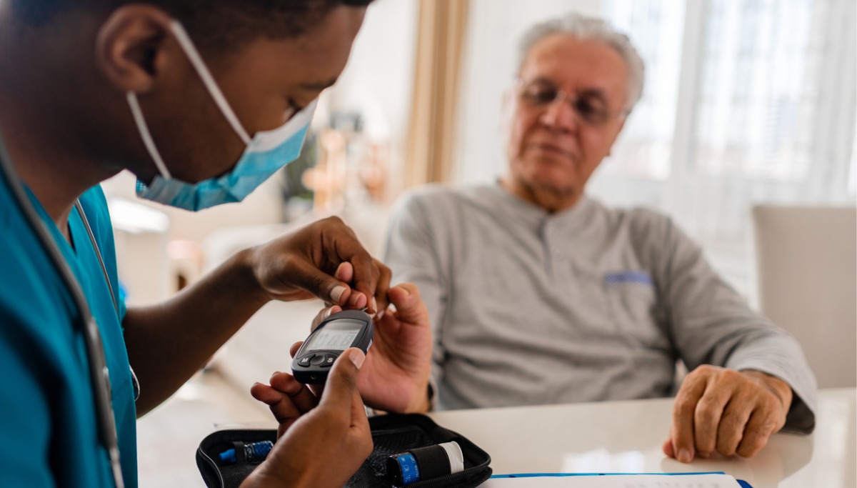 A nurse checking a person's blood sugar level