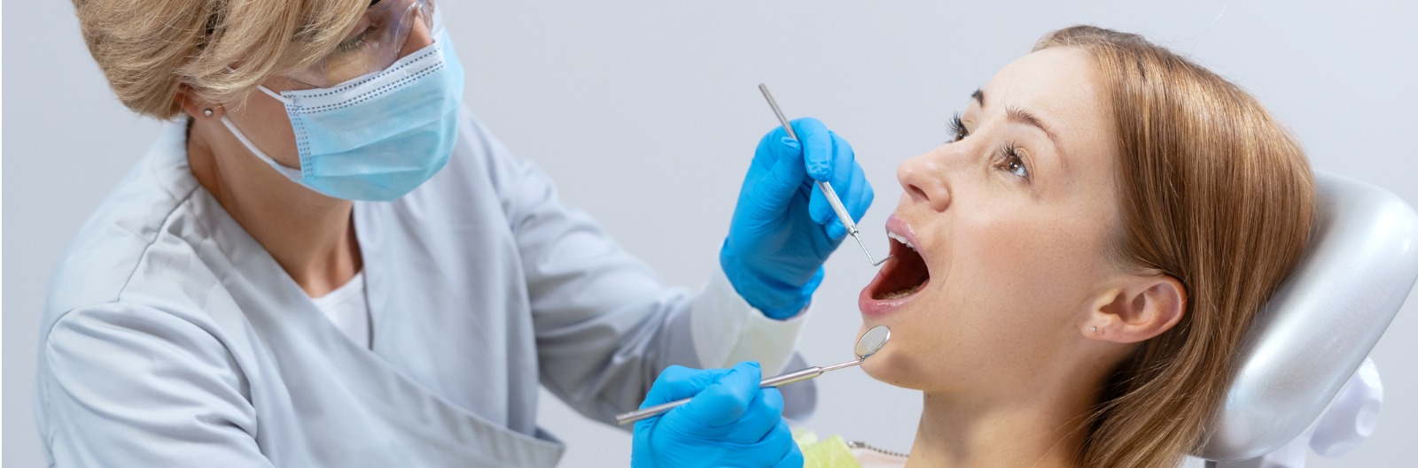 A dentist conducting an exam on a patient
