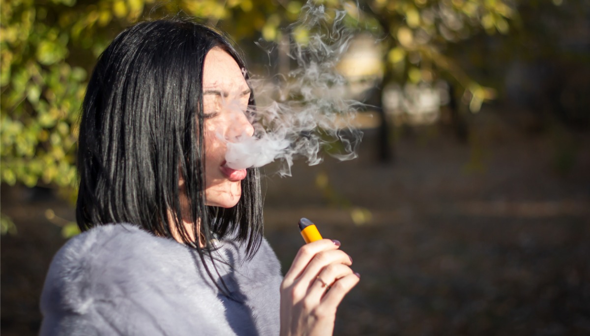 A girl exhaling smoke after vaping