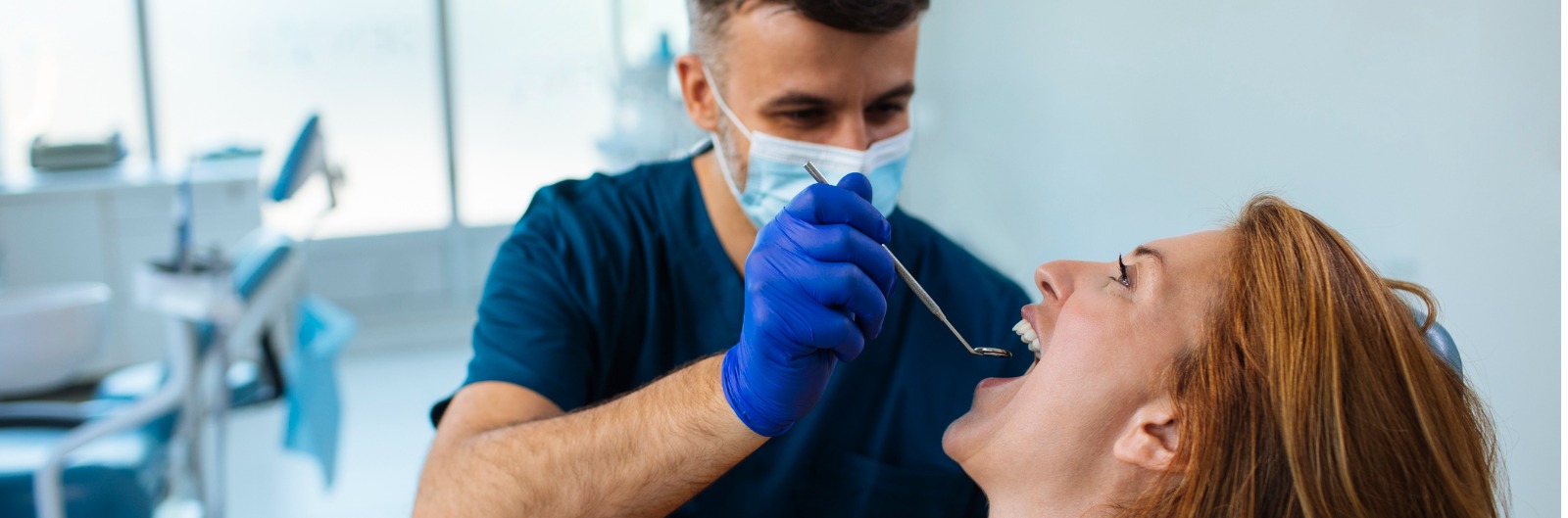 A dentist conducting an exam on a patient