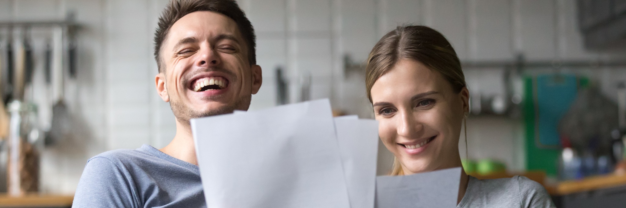 happy-couple-laughing-reading-EOB 2048x682.jpg