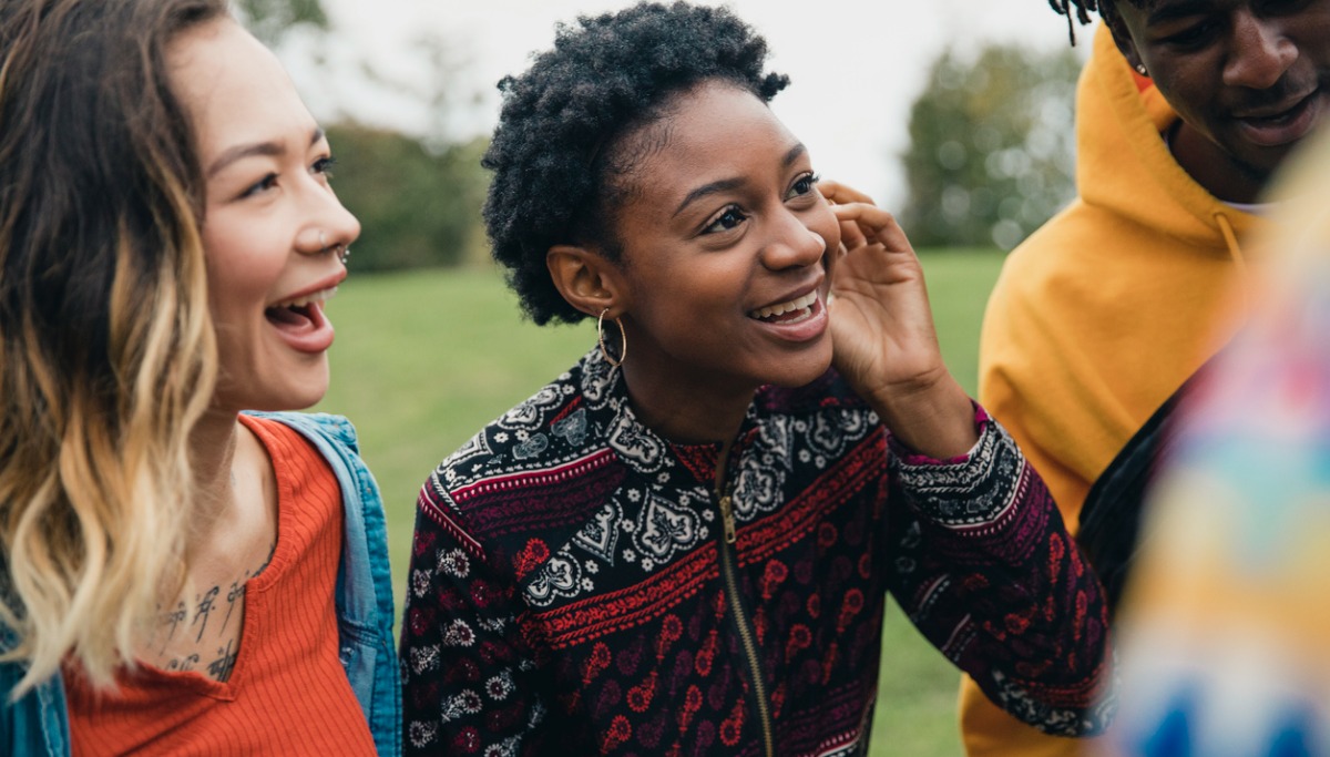 A group of friends laughing in a park