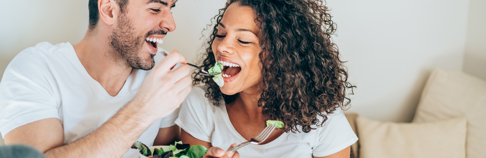 A couple eating salad together