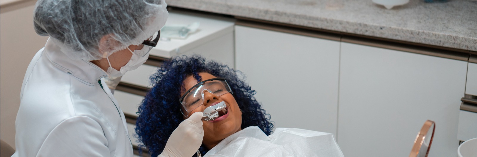 dentist-testing-dental-mold-on-patient-picture-1600x529.jpg