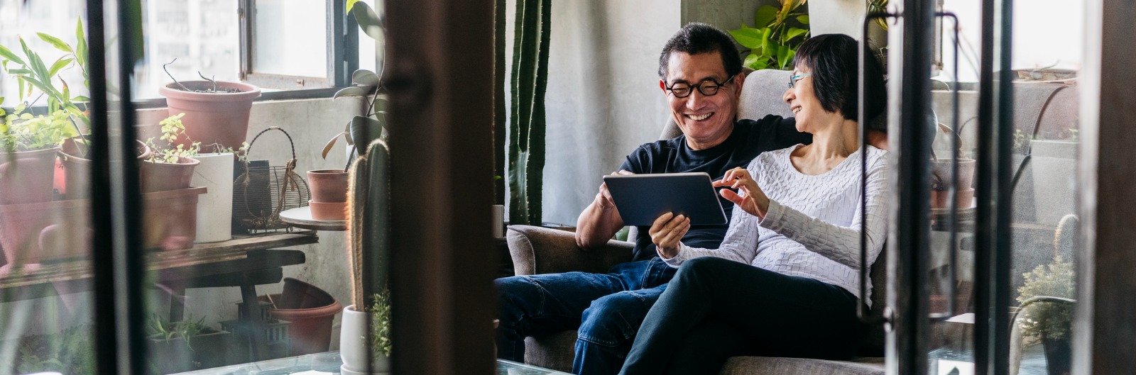 cheerful-chinese-couple-using-tablet-in-modern-chinese-apartment-picture-1600x529.jpg