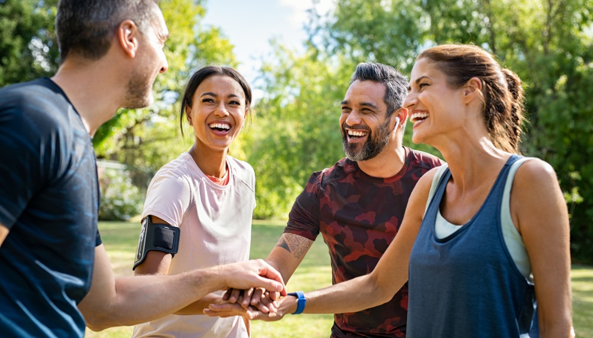 group-of-active-mature-friends-in-park-stacking-hands-1200x683.jpg