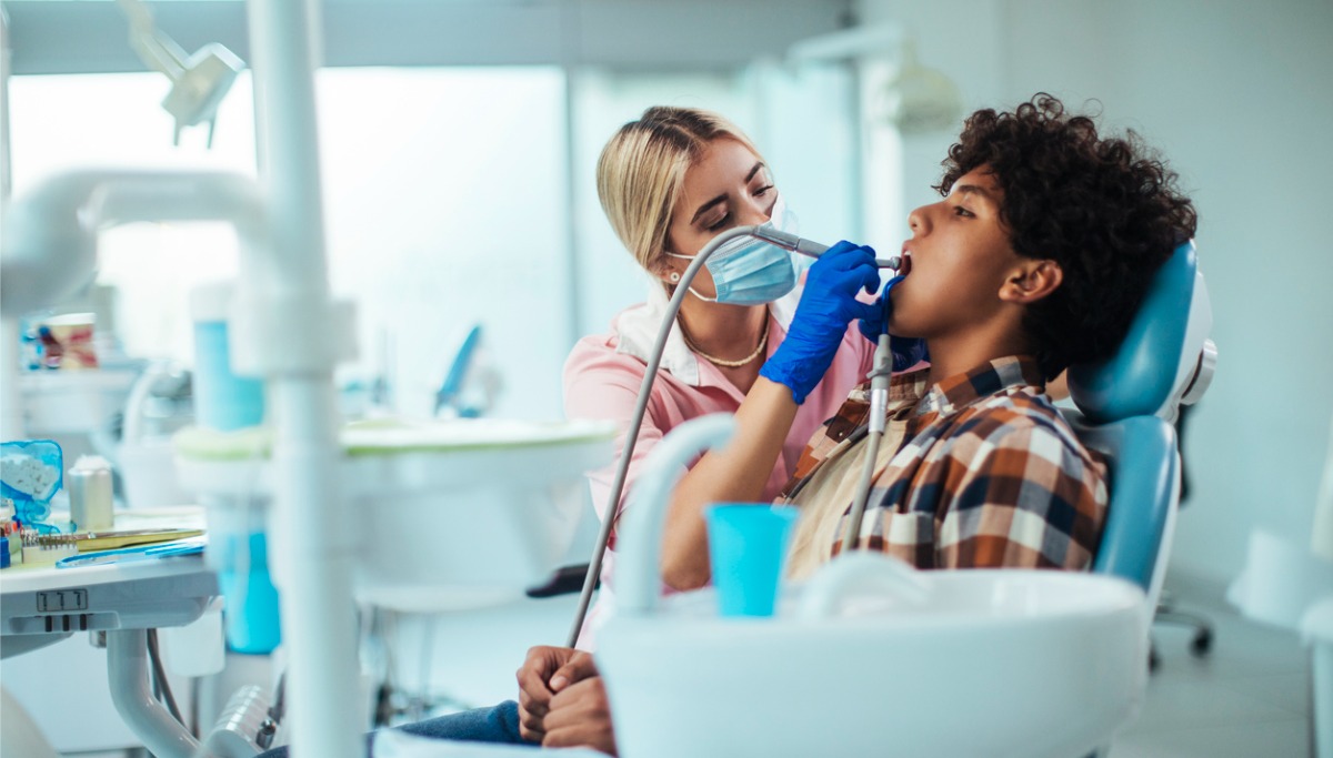 A dentist conducting an exam on a patient