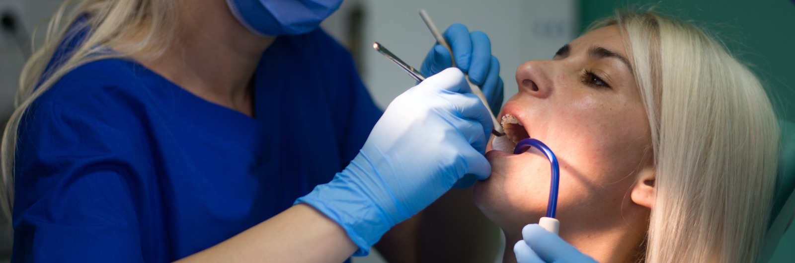 A dentist conducting an exam on a patient