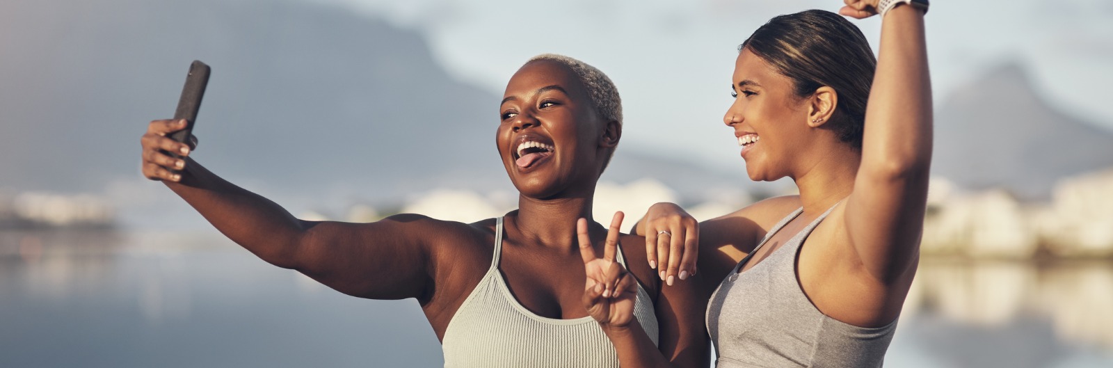 Two women taking a selfie outside while exercising
