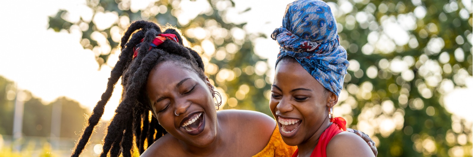 two-female-friends-with-smartphone-smiling-outdoors-picture-1600x529.jpg