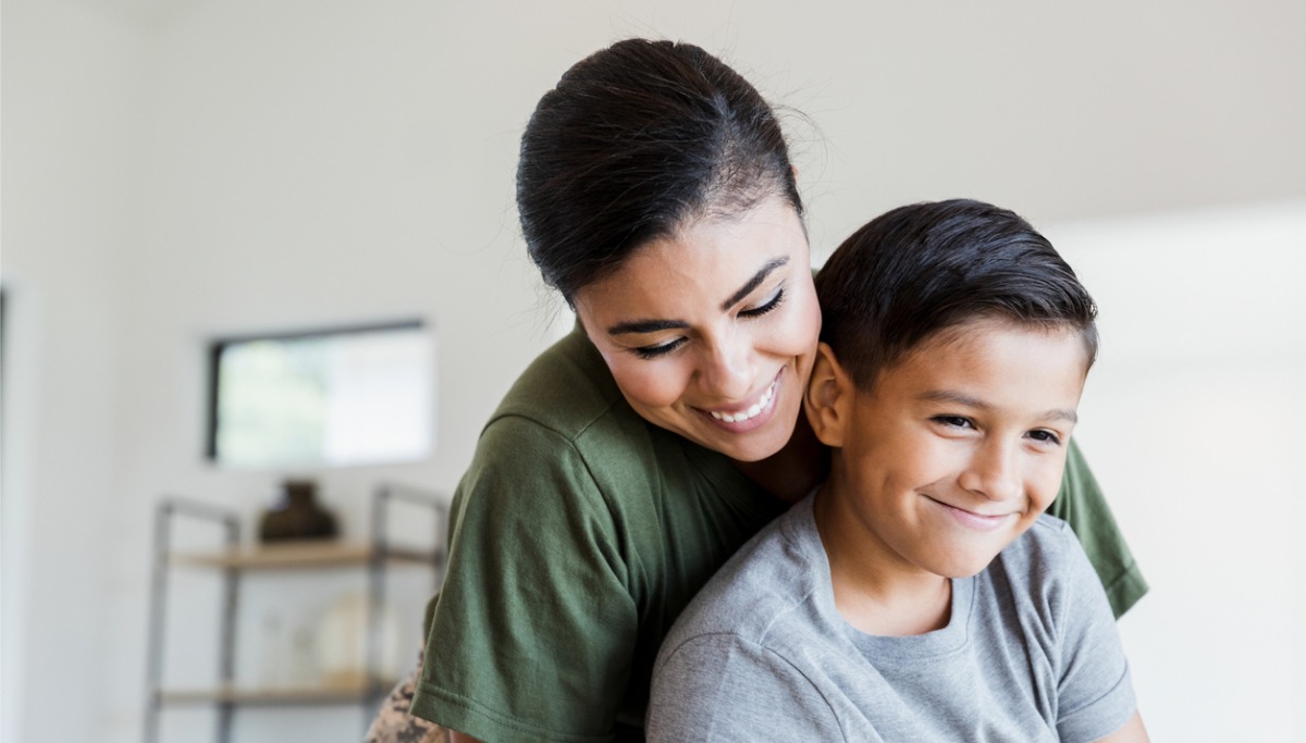 A mother and son smiling together