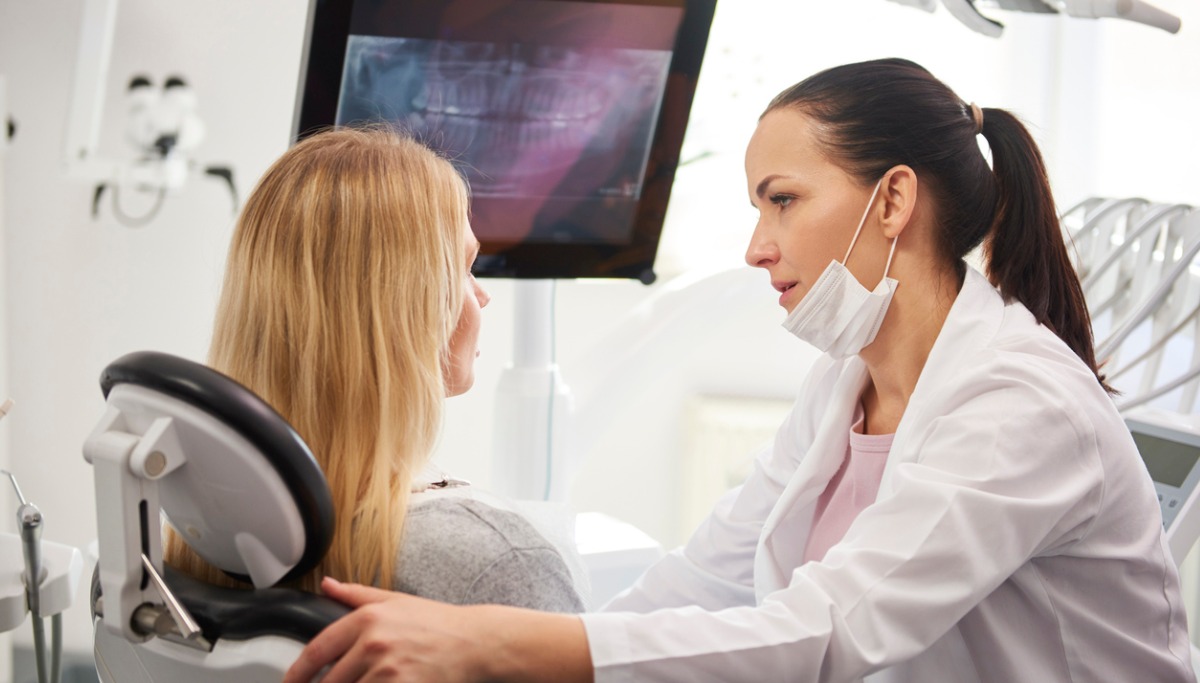 A dentist talking with a patient