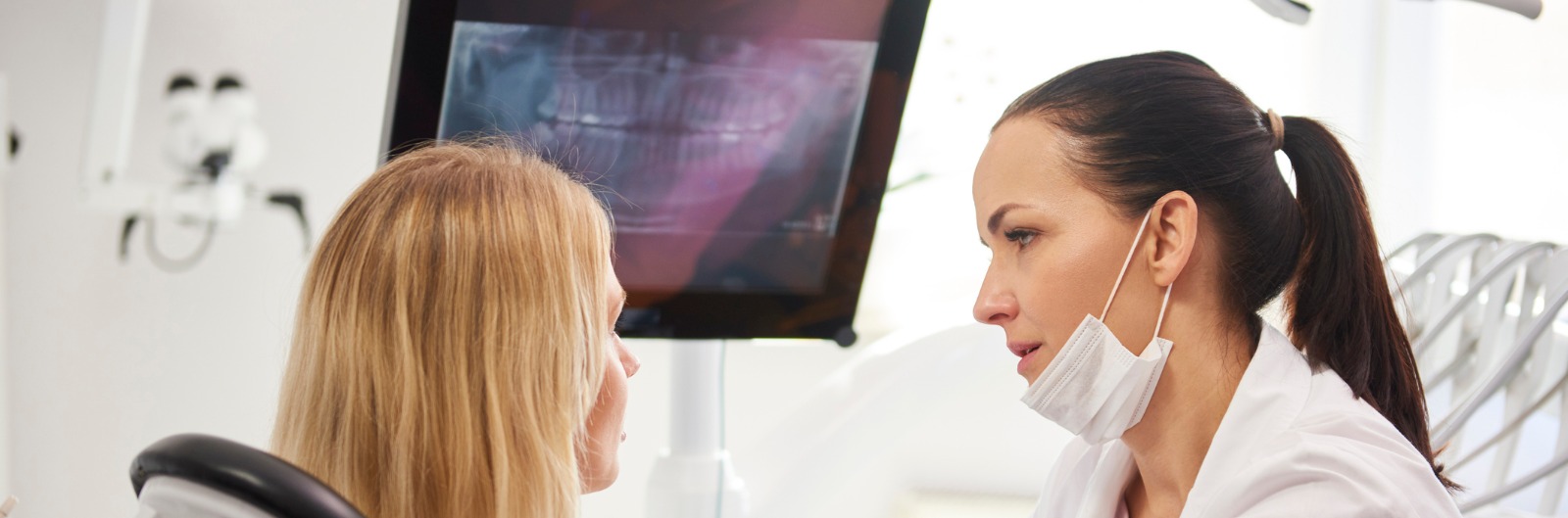 A dentist talking with a patient