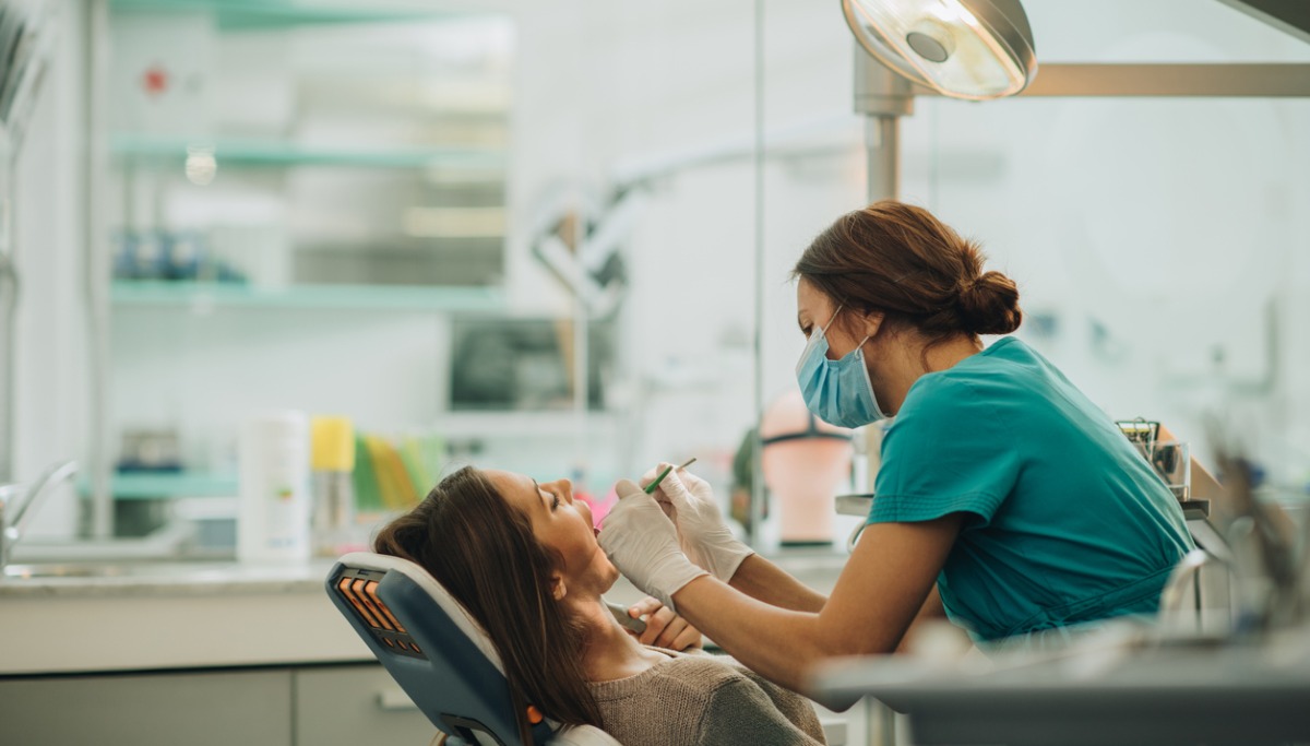 young-woman-having-her-teeth-checked-during-appointment-at-dentists-picture-1200x683.jpg