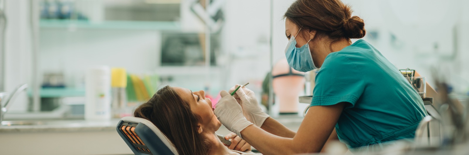 young-woman-having-her-teeth-checked-during-appointment-at-dentists-picture-1600x529.jpg