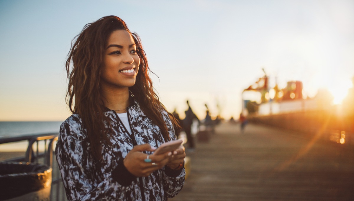 young-fashionable-woman-texting-on-her-phone-in-santa-monica-picture 1200 x 683.jpg