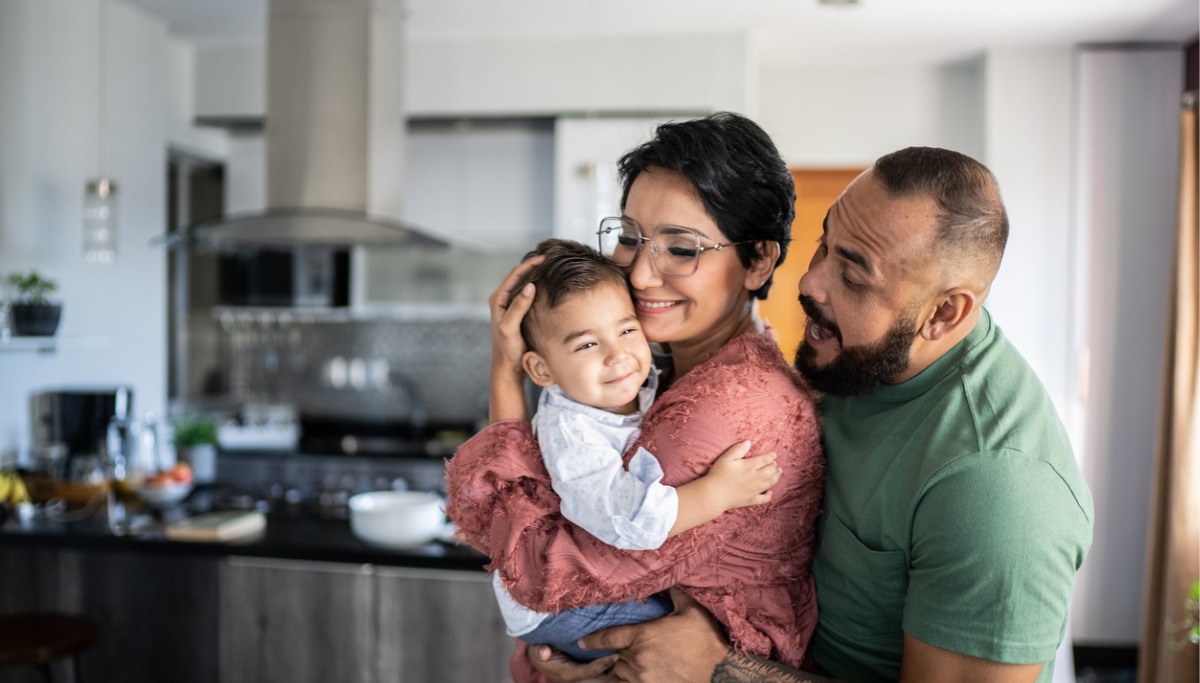 A mother and father holding their child