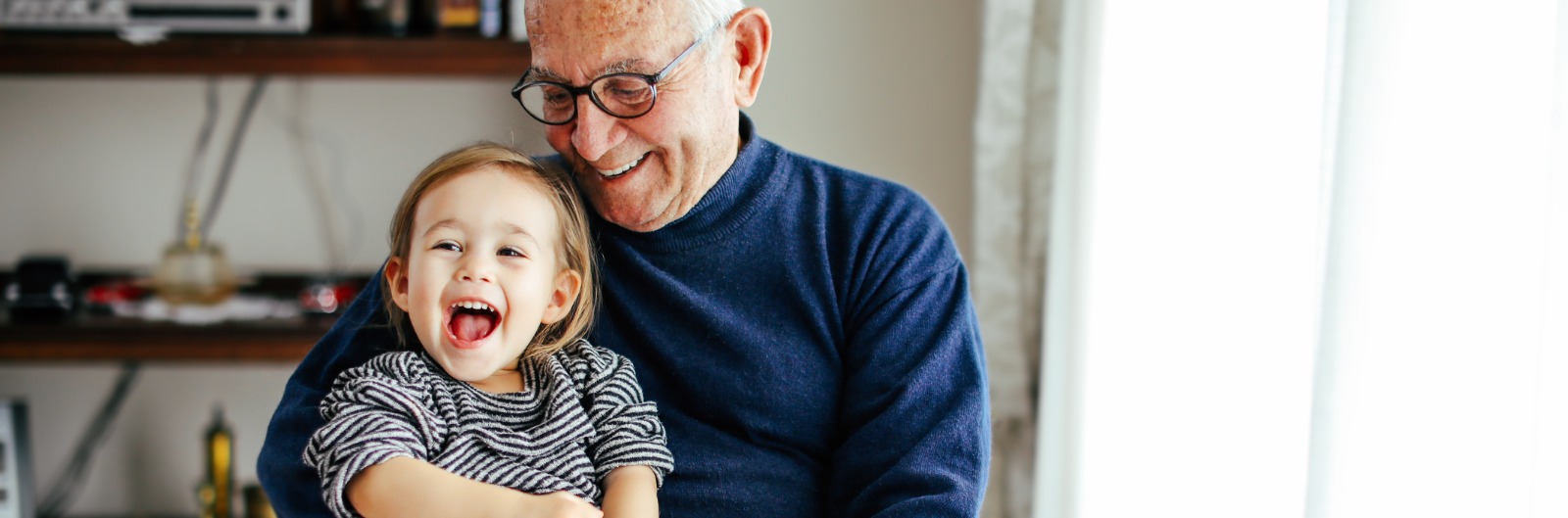 A grandfather holding his granddaughter