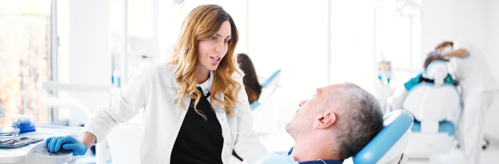 A dentist talking with a patient