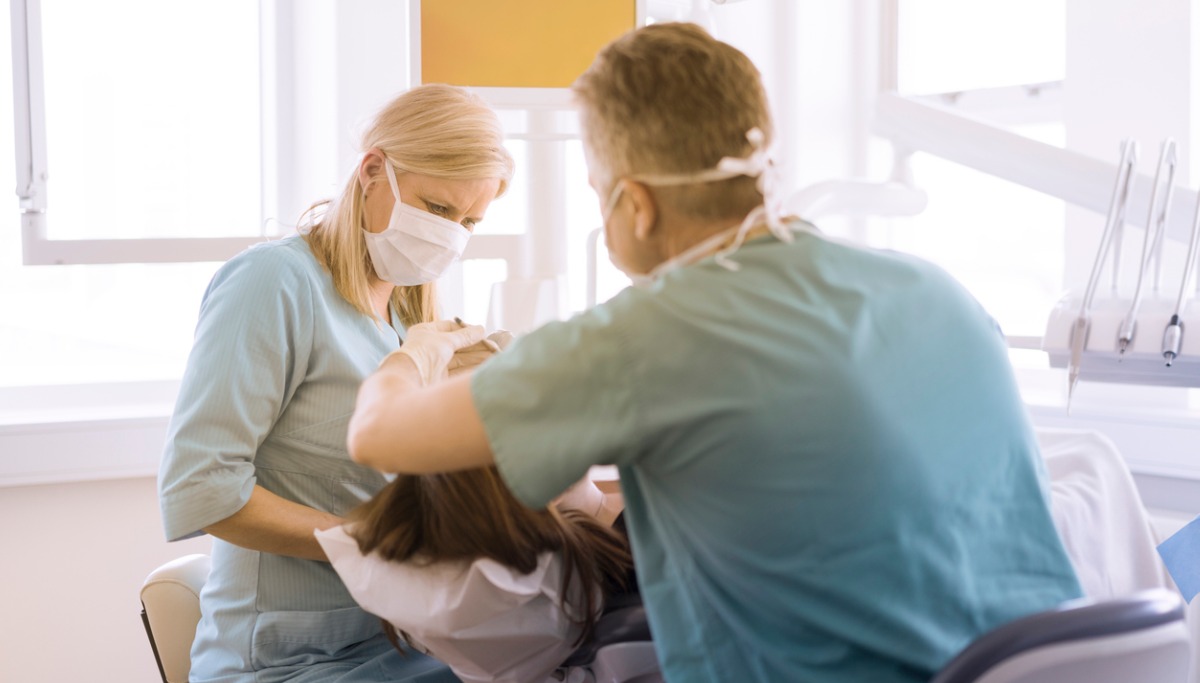 Dentists conducting a root canal